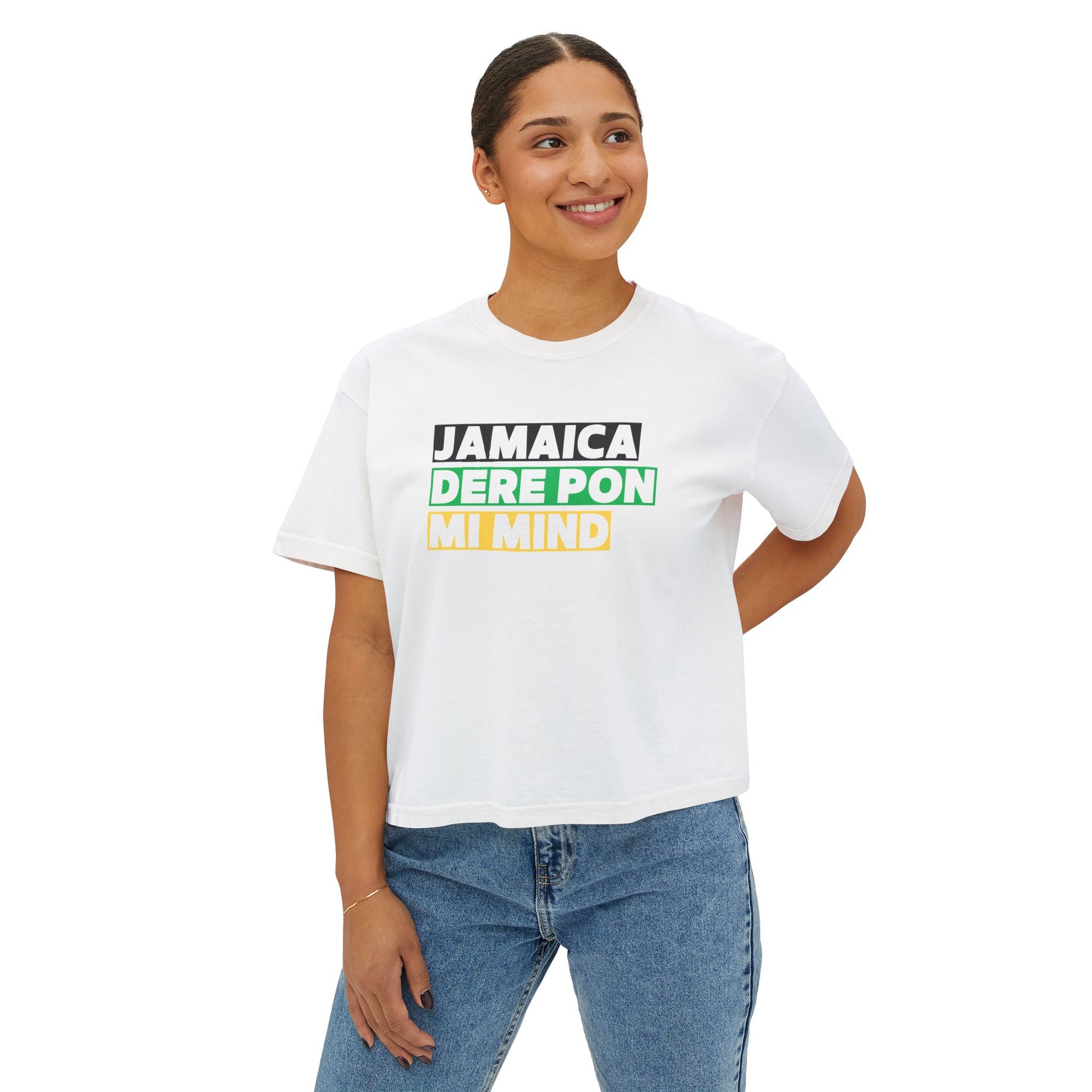 Woman wearing white Cropped Graphic T-shirt with 'Jamaica Dere Pon Mi Mind' printed in bold text with a Black, Green and Gold Background.