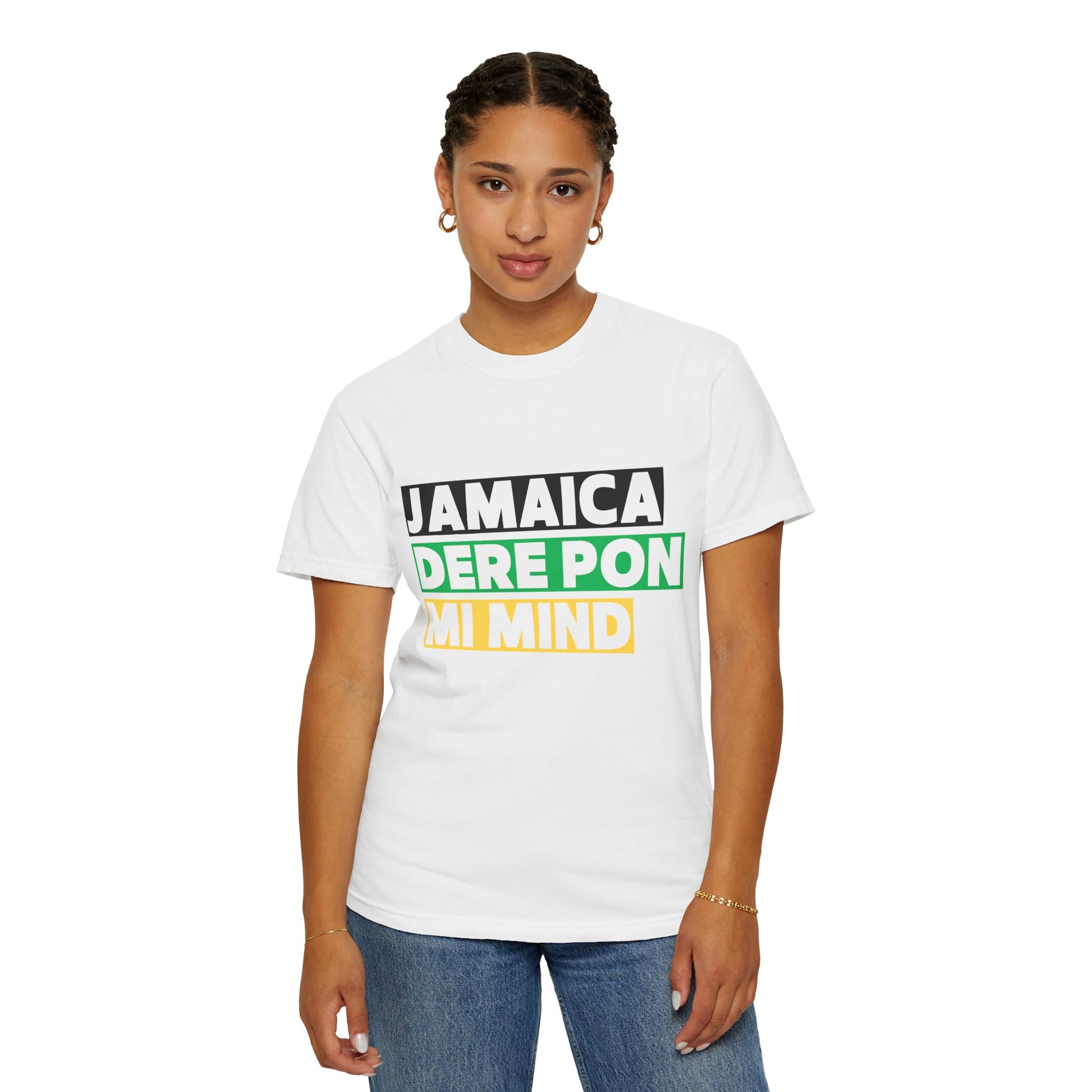 Woman wearing a white unisex graphic t-shirt with 'Jamaica dere pon mi mind' written in bold lettering on a black, green and gold backgroud
