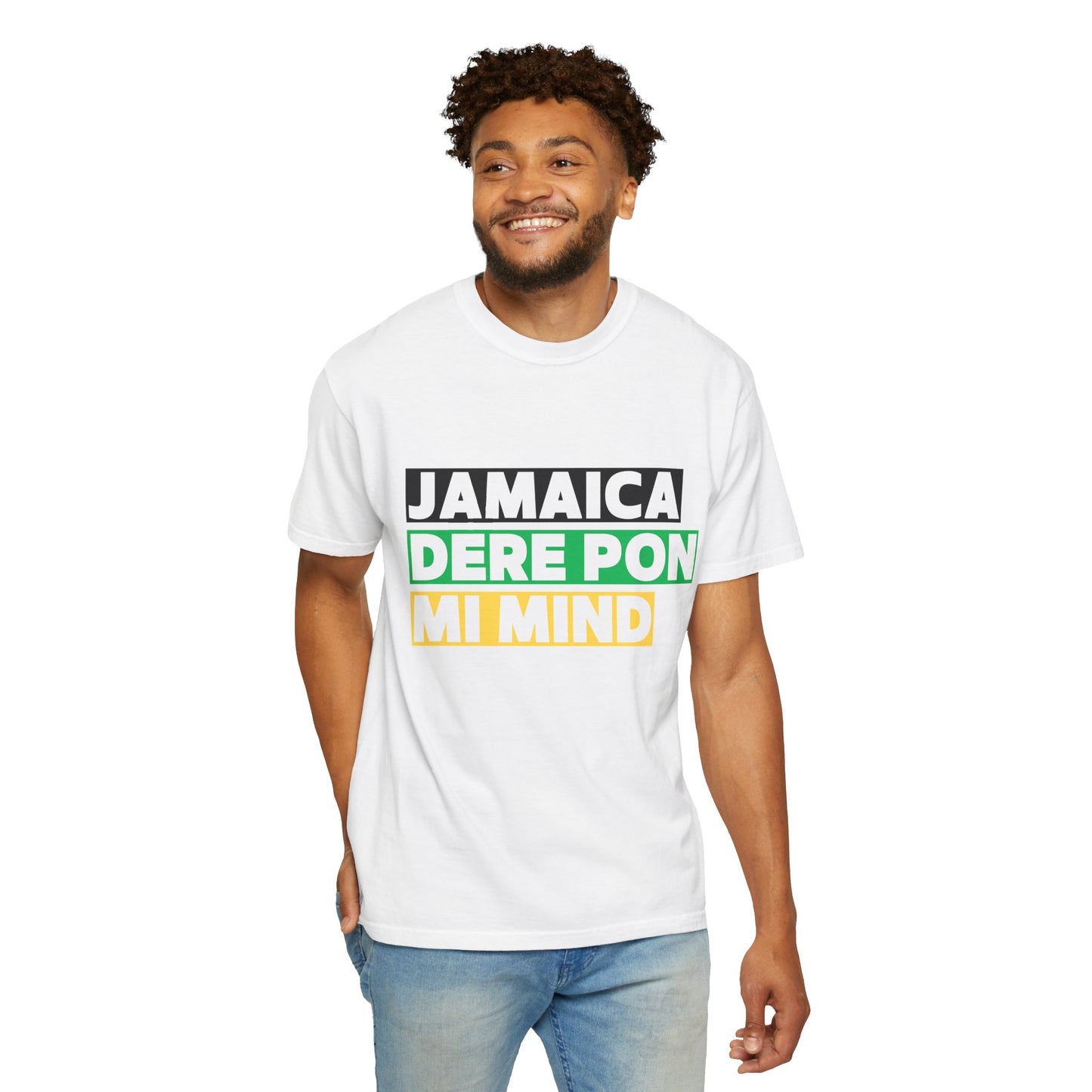 Man wearing a white unisex graphic t-shirt with 'Jamaica dere pon mi mind' written in bold lettering on a black, green and gold backgroud